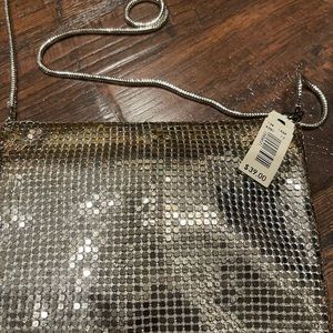 Silver purse. Carry on your shoulder or tie a knot in the chain for a wristlet.